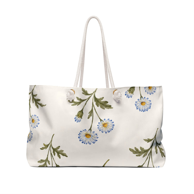 Daisy Floral Weekender Bag — angled side view showing the rope handles and grommet hardware, watercolor daisy print in light blue on cream