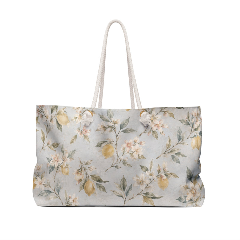 Lemon Blossom Weekender Bag — angled view showing cream rope handles and gold-tone grommets