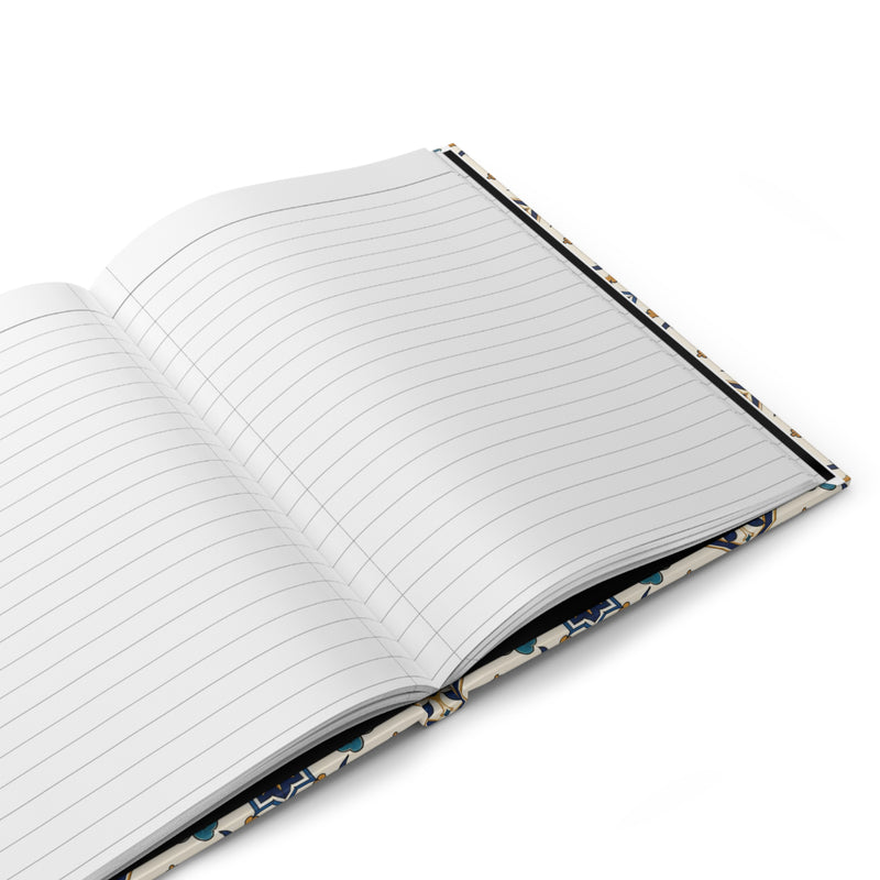 Blue Floral Tile Hardcover Journal styled on a desk with stationery