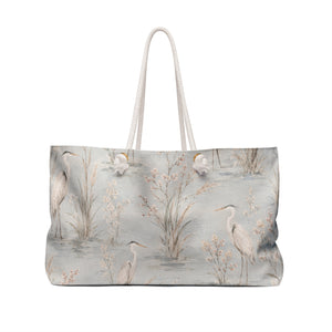 Heron Marsh Weekender Bag — angled view showing cotton rope handles and gold-toned grommets