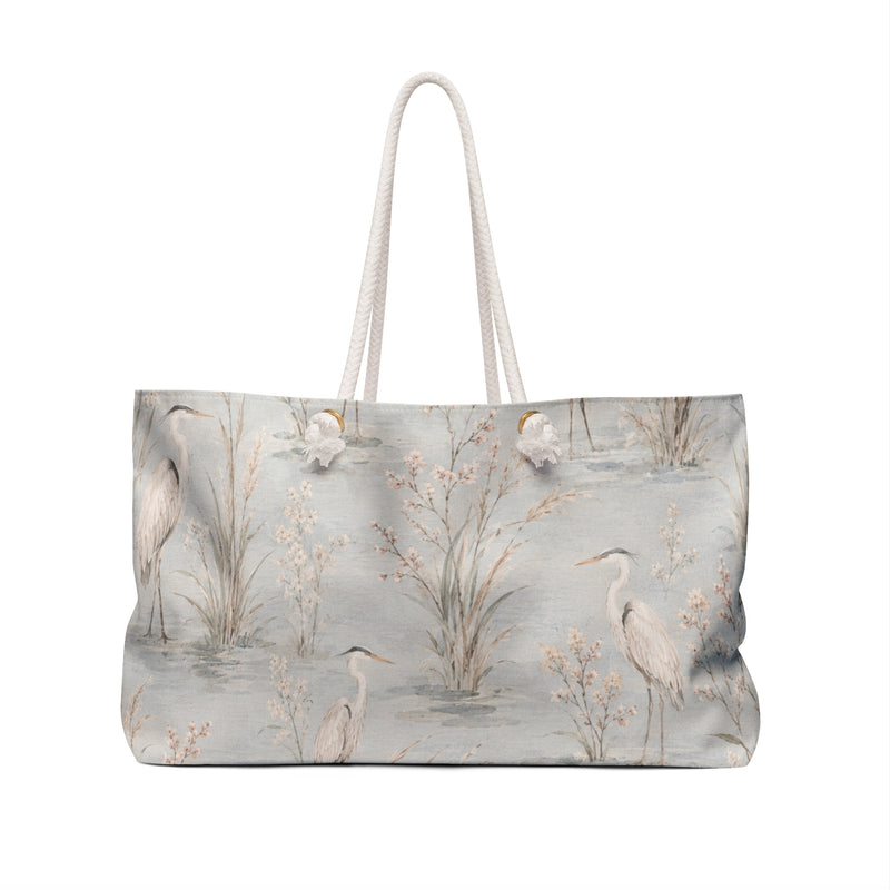 Heron Marsh Weekender Bag — angled view showing cotton rope handles and gold-toned grommets