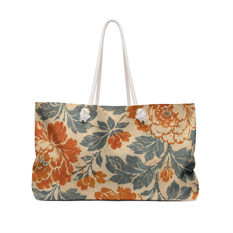 Vintage Floral Weekender Bag Monogram D — angled side view showing the rope handles and grommet hardware, faded vintage floral print