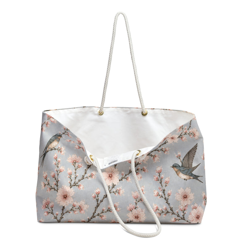 Close-up of the cherry blossom and swallow print detail on the Floral Bird Weekender Bag