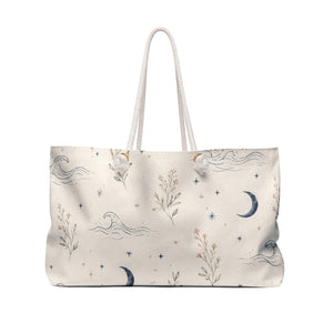 Celestial Moon & Wildflower Weekender Bag — angled view showing cotton rope handles and gold-color grommets