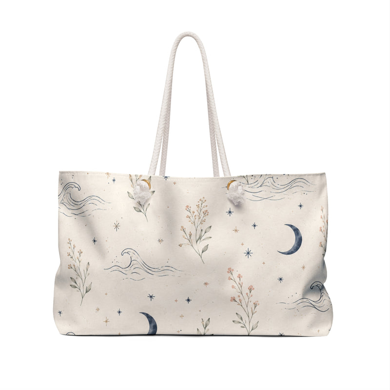 Celestial Moon & Wildflower Weekender Bag — angled view showing cotton rope handles and gold-color grommets