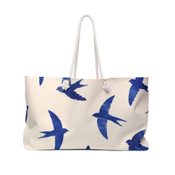 Blue Swallow Print Weekender Bag — front view showing the cobalt swallow pattern on cream fabric