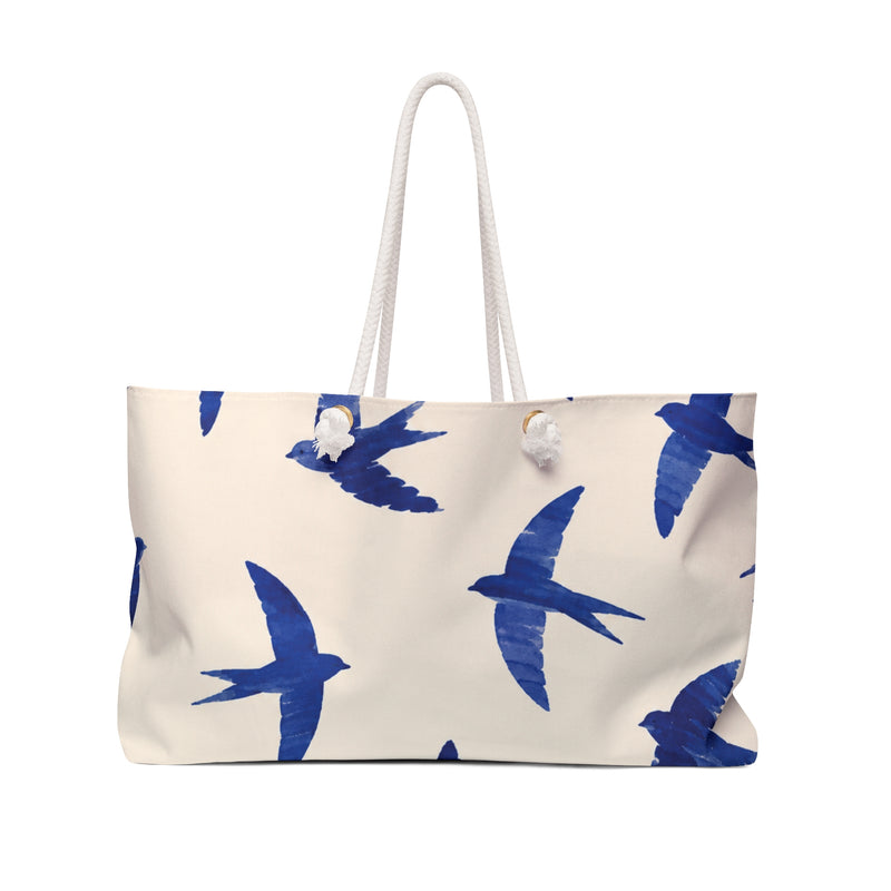 Blue Swallow Print Weekender Bag — front view showing the cobalt swallow pattern on cream fabric