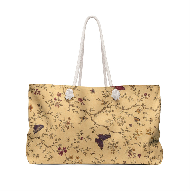 Butterfly Floral Weekender Bag carried on the shoulder with cream rope handles