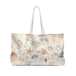 Seaside Shell Weekender Bag — angled view showing cream rope handles and gold-color grommets