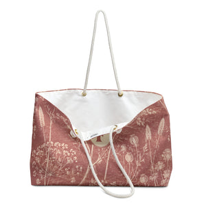 Floral Monogram "F" Weekender Bag – close-up detail of the monogrammed "F" badge on the wildflower print