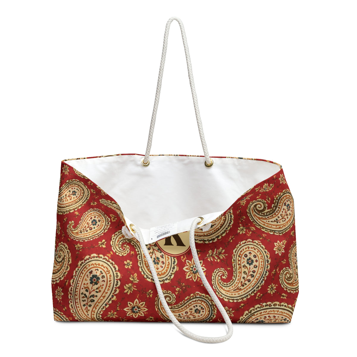 Close-up of the personalized "K" monogram and gold-tone grommets on the Paisley Monogram Weekender Bag