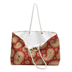 Close-up of the personalized "K" monogram and gold-tone grommets on the Paisley Monogram Weekender Bag