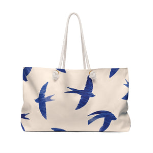 Swallow Print Monogram Weekender Bag carried on the shoulder with rope handles