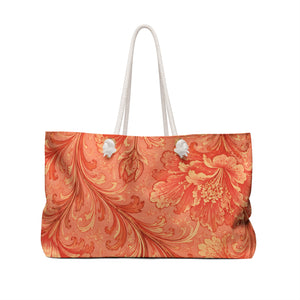 Coral Baroque Weekender Bag — angled side view showing the rope handles and grommet hardware, painterly coral-and-peach floral swirl print