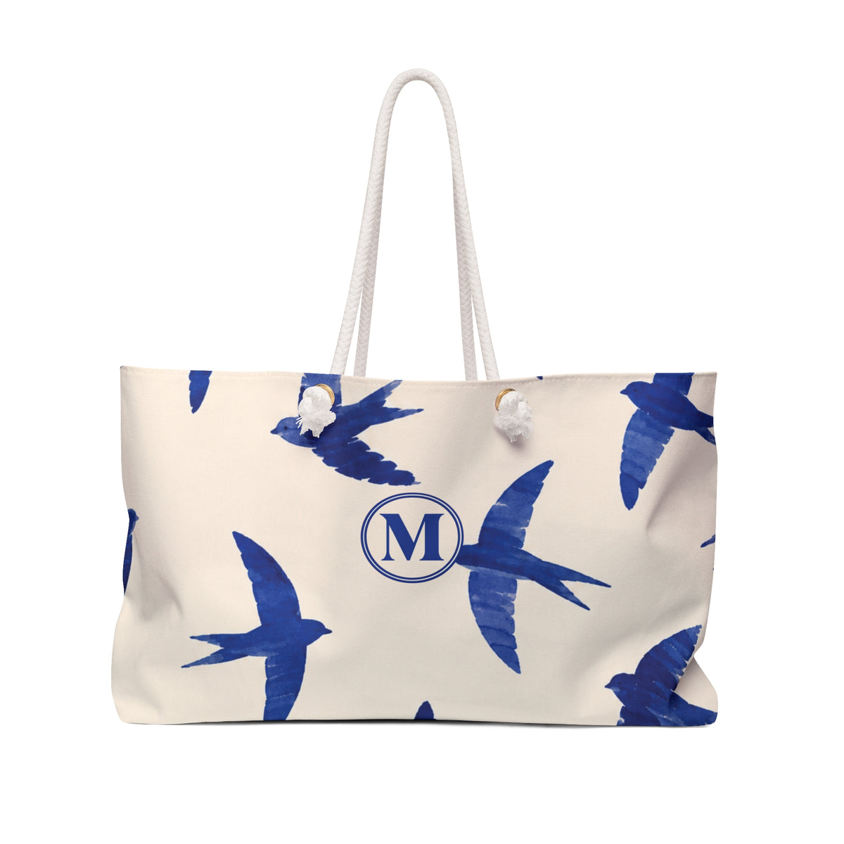 Swallow Print Monogram Weekender Bag — front view showing the cobalt swallow pattern and "M" monogram
