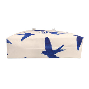 Swallow Print Monogram Weekender Bag shown flat, highlighting the T-bottom structure and soft cream lining