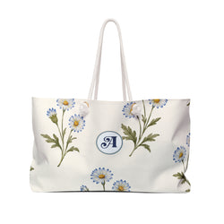 Monogram A Daisy Weekender Bag — front view showing the full exterior print, soft blue daisy print on cream canvas