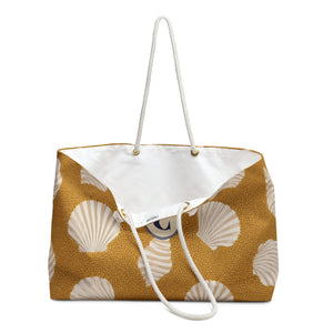 Shell Pattern Weekender Bag — close-up of the fabric print and hardware detail, scattered scallop shell print on golden sand