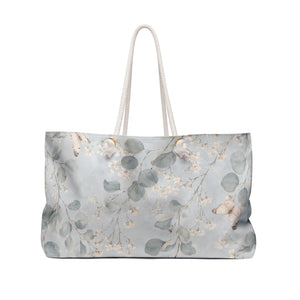 Floral Eucalyptus Weekender Bag — angled view showing cream rope handles and gold-color grommets