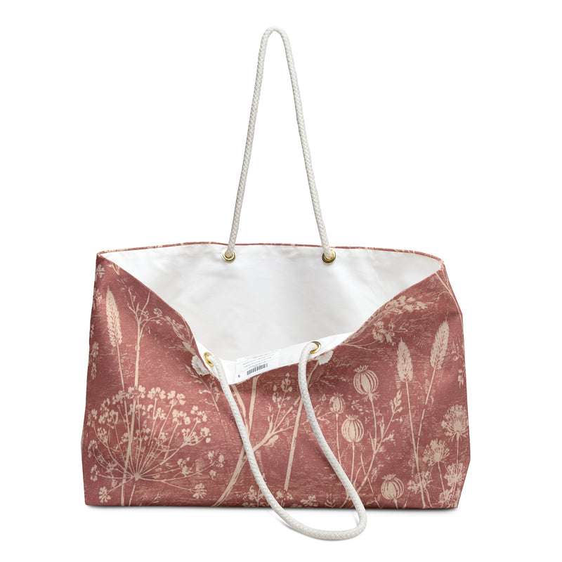 Botanical Dusty Rose Weekender Bag — close-up of the fabric print and hardware detail, delicate wildflowers in a faded botanical sketch style on washed-rose exterior